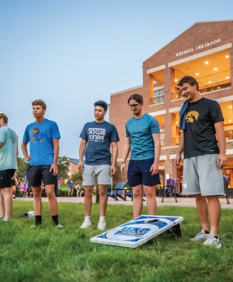 Students outdoors playing lawn games.